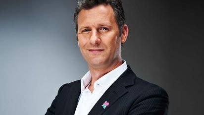 Promotional photograph of Adam Hills.