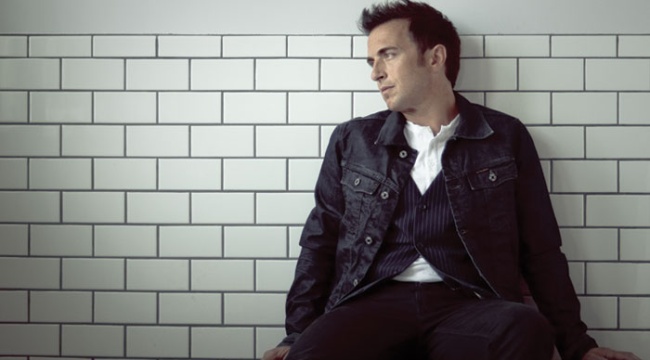 Promotional photograph of Colin James.