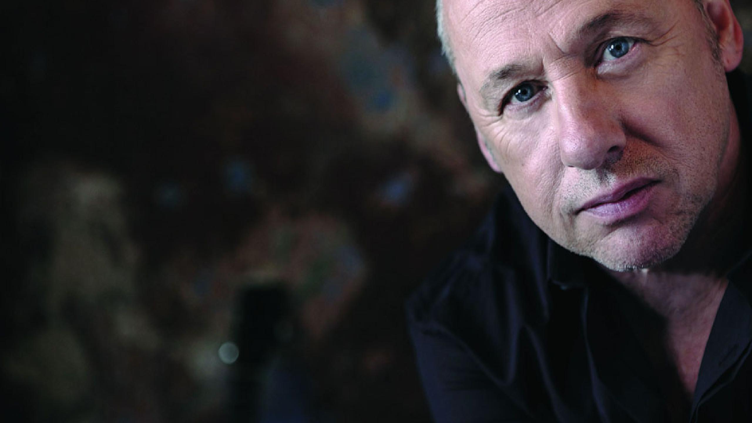 Promotional photograph of Mark Knopfler.